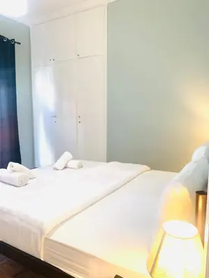 a bedroom with a large white bed with a mirror at Athens City Themis 9 in Athens