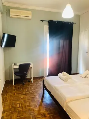 a room with two beds and a desk and a computer at Athens City Themis 9 in Athens
