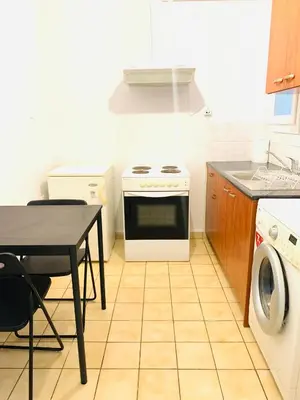 a kitchen with a stove and a table and a sink at Athens City Themis 9 in Athens