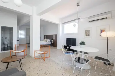 a living room with a table and chairs at Loft at historical center of Athens Acropolis View in Athens