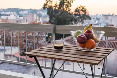 a bowl of fruit sitting on a table on a balcony at Loft at historical center of Athens Acropolis View in Athens