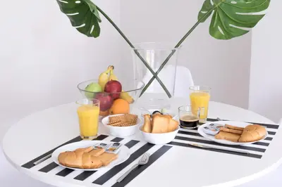 a table with a tray of breakfast foods and orange juice at Loft at historical center of Athens Acropolis View in Athens