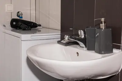 a bathroom sink with a faucet next to a mirror at Loft at historical center of Athens Acropolis View in Athens