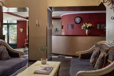 a living room with two couches and a clock on a wall at Delphi Art Hotel by Prima Hotels in Athens