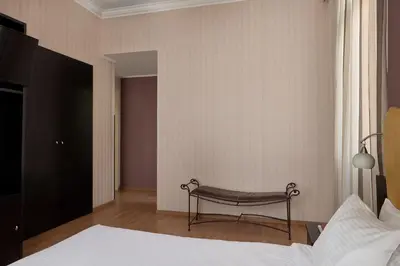 a bedroom with a bed with a bench in it at Delphi Art Hotel by Prima Hotels in Athens