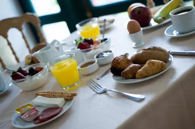 a table with breakfast foods and drinks on it at Delphi Art Hotel by Prima Hotels in Athens