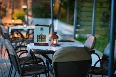 a table with a book and a candle on it at Delphi Art Hotel by Prima Hotels in Athens