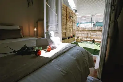 a bedroom with a bed with two flowers on it at Cozy Apartment in the heart of Athens! in Athens