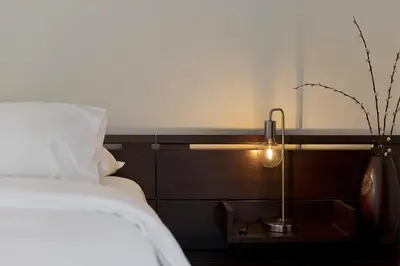 a bedroom with a bed and a lamp on a table at Seascape Modern Vouliagmeni Apt near Beaches in Athens