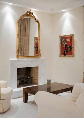 a living room with a mirror and a fireplace at Voula Riviera Apartment in Athens