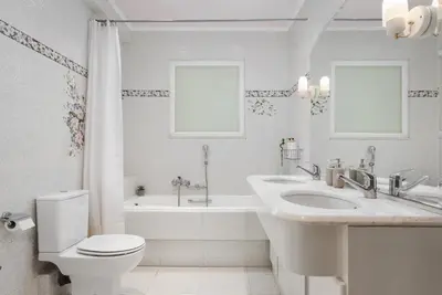 a bathroom with a sink and a toilet and a tub at Voula Riviera Apartment in Athens