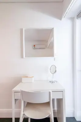 a white desk in a room with a mirror at Sun & Sea Suite, Kavouri in Athens