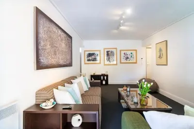 a living room with a couch and a table at Sun & Sea Suite, Kavouri in Athens