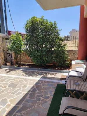 a patio with two benches and a tree at Pegasus cosy house in Athens