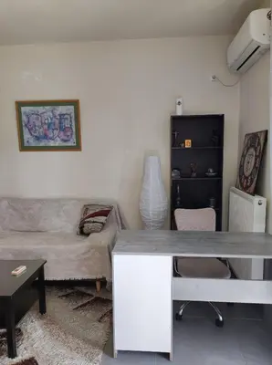 a living room with a table and a couch at Pegasus cosy house in Athens