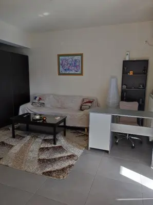 a living room with a couch and a table at Pegasus cosy house in Athens