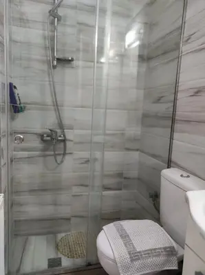 a bathroom with a shower with a toilet and a sink at Pegasus cosy house in Athens
