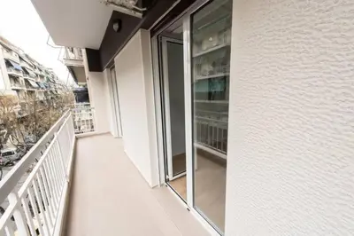an empty balcony of a building with glass doors at Spacious flat 10min from subway stations (BODA_B3) in Athens