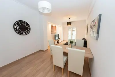a dining room and living room with a table and chairs at Spacious flat 10min from subway stations (BODA_B3) in Athens