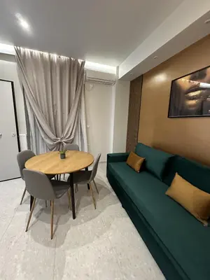 a living room with a green couch and a table at Smart Lux Apartment A in Athens