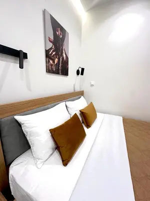 a bedroom with a bed with white sheets and pillows at Smart Lux Apartment A in Athens