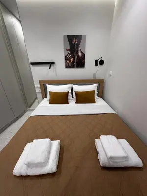 a bedroom with a large bed with two towels on it at Smart Lux Apartment A in Athens
