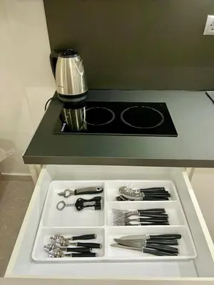 a white drawer with utensils on a kitchen counter at Smart Lux Apartment A in Athens