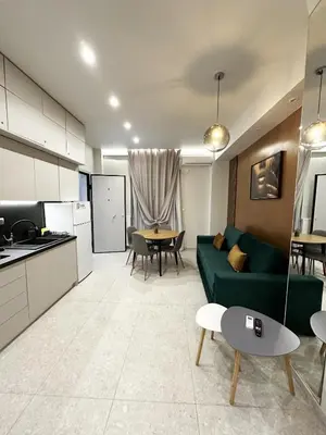 a living room with a green couch and a table at Smart Lux Apartment A in Athens