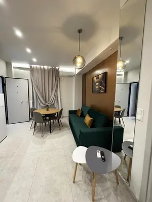 a living room with a green couch and a table at Smart Lux Apartment A in Athens