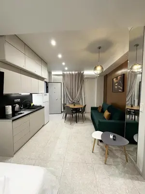 a living room with a green couch and a table at Smart Lux Apartment A in Athens