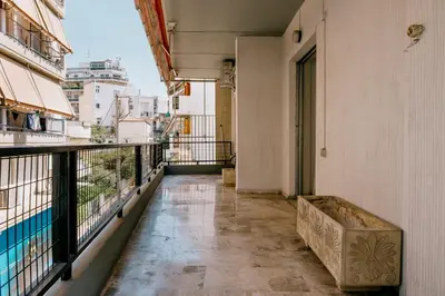a balcony with a bench on the side of a building at Sq Varnava apartment Athens in Athens