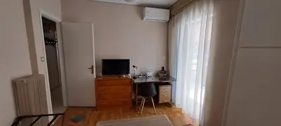 a room with a desk with a television on a dresser at Sq Varnava apartment Athens in Athens