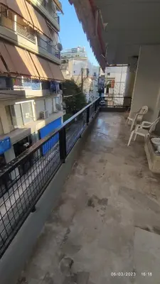 an empty balcony of a building with a fence at Sq Varnava apartment Athens in Athens