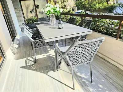 a dining table and chairs on a patio at Filothei Luxury Apartment 110m2 in Athens