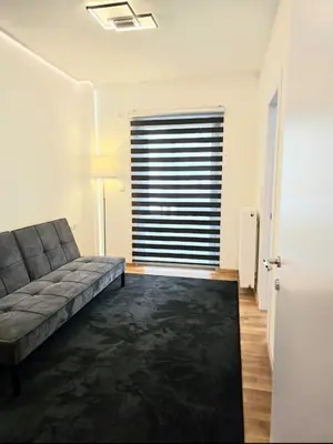 a living room with a couch and a window at Filothei Luxury Apartment 110m2 in Athens