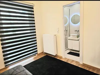 a bathroom with a large window and a sink at Filothei Luxury Apartment 110m2 in Athens