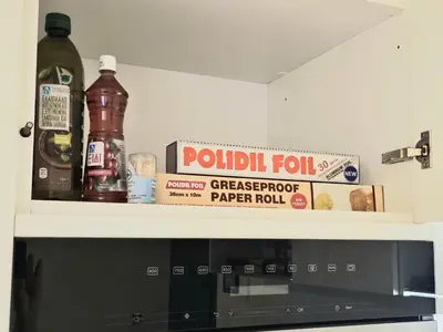 a shelf above a microwave with ingredients on it at Filothei Luxury Apartment 110m2 in Athens