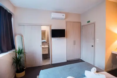 a hotel room with a bed and a bathroom at Athens Gem in Athens