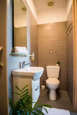 a bathroom with a toilet and a sink at Athens Gem in Athens