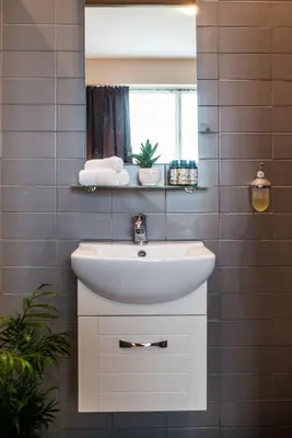 a bathroom with a white sink and a mirror at Athens Gem in Athens