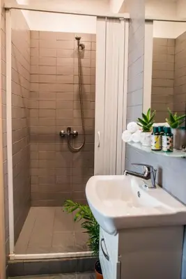 a bathroom with a shower and a sink at Athens Gem in Athens