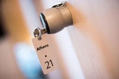 a tag hanging from a door handle with a tag on it at Athens Gem in Athens