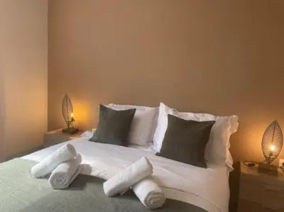 a bedroom with a bed with towels on it at Athens Gem in Athens