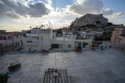 a view of a city from the roof of a building at Plaka With Acropolis Rooftop View Access in Athens