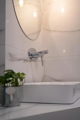 a bathroom sink with a faucet and a mirror at Plaka With Acropolis Rooftop View Access in Athens