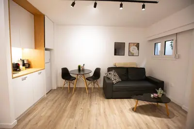 a living room with a couch and a table at Plaka With Acropolis Rooftop View Access in Athens