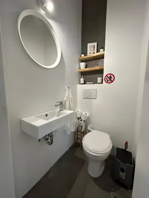 a bathroom with a sink and a toilet and a mirror at Harmony Luxury Grand Suite in Athens