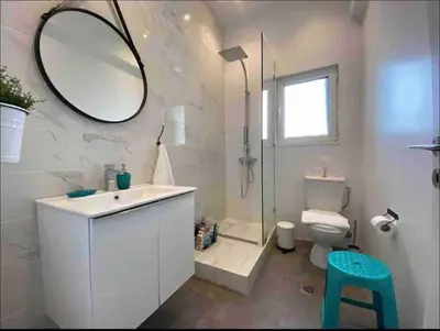 a bathroom with a sink and a mirror and a toilet at Harmony Luxury Grand Suite in Athens