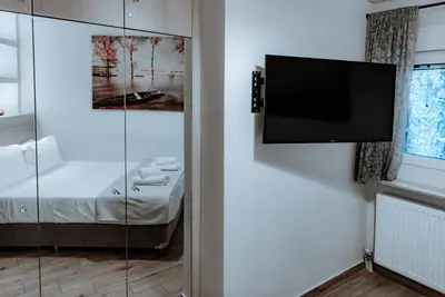 a living room with a flat screen tv on a wall at Acropolis Museum Stylish Apartments in Athens