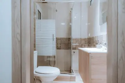 a bathroom with a toilet and a shower and a sink at Acropolis Museum Stylish Apartments in Athens